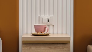 A modern bathroom with a wooden vanity, a pink bowl, and a wall-mounted light fixture. - La Casa delle Dee – Self Check-in (Bologna)