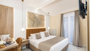 A modern hotel room with a large bed, a desk with a chair, a television, and a large window with curtains. - La Casa delle Dee – Self Check-in (Bologna)