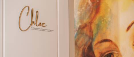 A wall with a nameplate and a partial view of a painting.