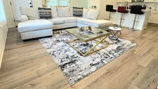 A modern living room with a sectional sofa, a glass coffee table, and a ceiling fan. - The Tigers Pathway House near LSU Stadium - BC1034 (Baton Rouge)