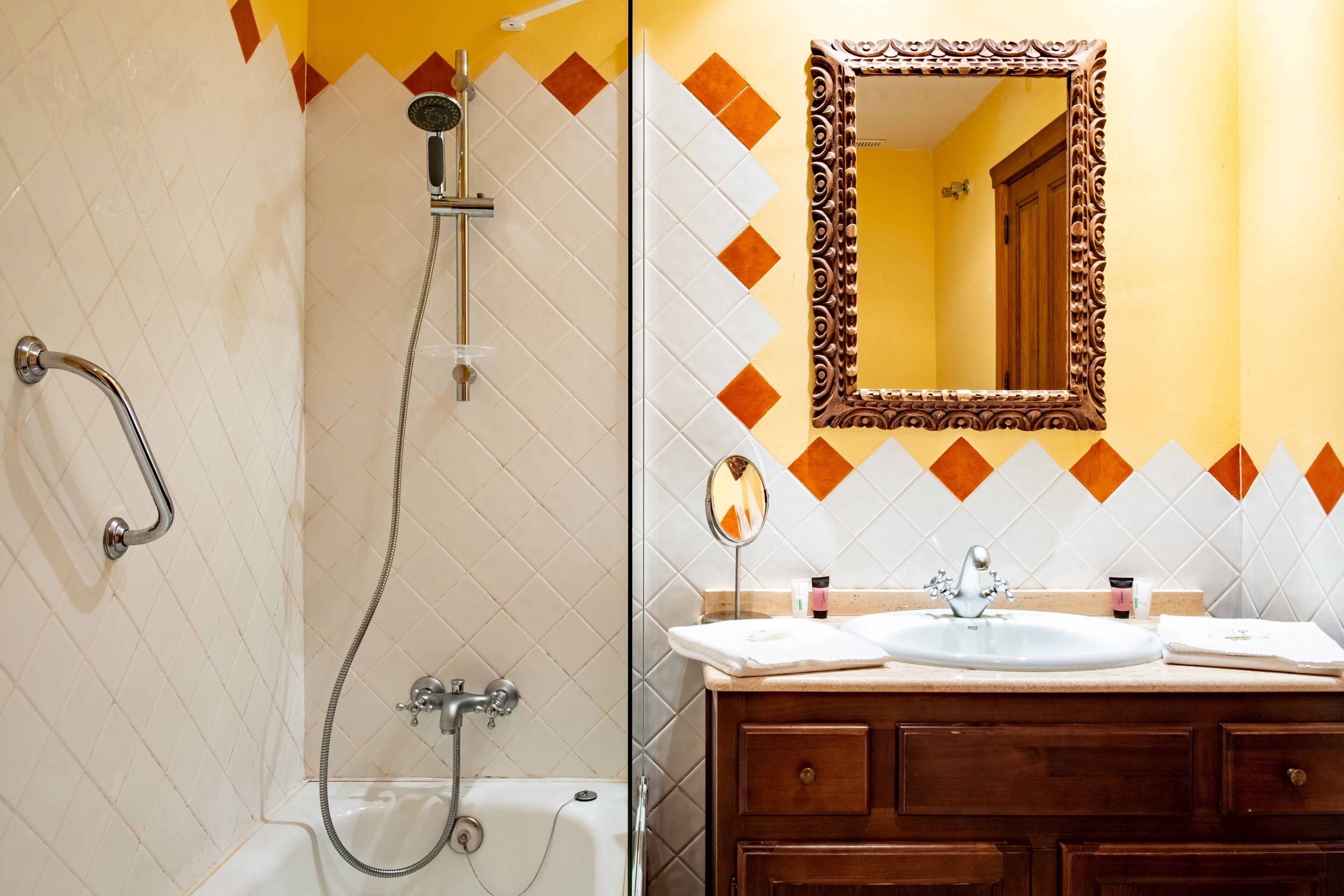 A bathroom with a shower, a sink, and a mirror.