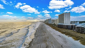 A beach with a row of high-rise buildings along the shore. - Picture Perfect: Tilghman Beach & Racquet Club, Steps to the Beach (North Myrtle Beach)