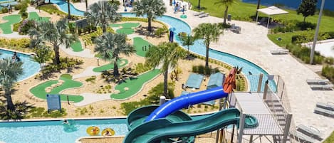 A resort with a large pool, water slides, and a golf course.