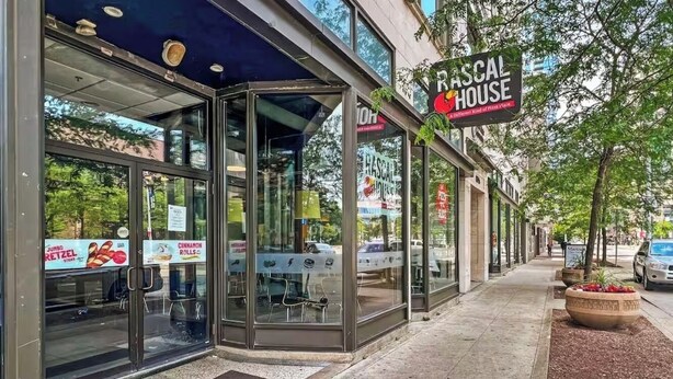 A restaurant with a glass front and a sign reading "RASCAL HOUSE".