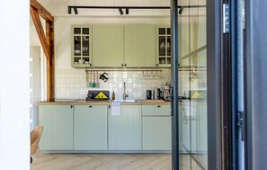 Fridge, stovetop, dishwasher, coffee/tea maker