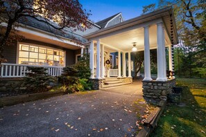 A house with a covered porch, stone foundation, and a front door with a wreath. - West Point Summer Pool Jacuzzi Events Pets OK (Cornwall)