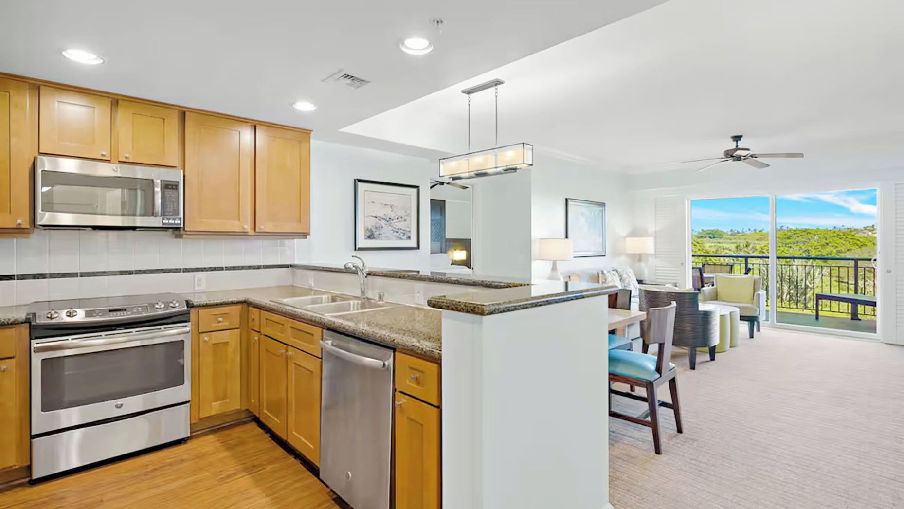 A modern kitchen with stainless steel appliances, wooden cabinets, and a large island.