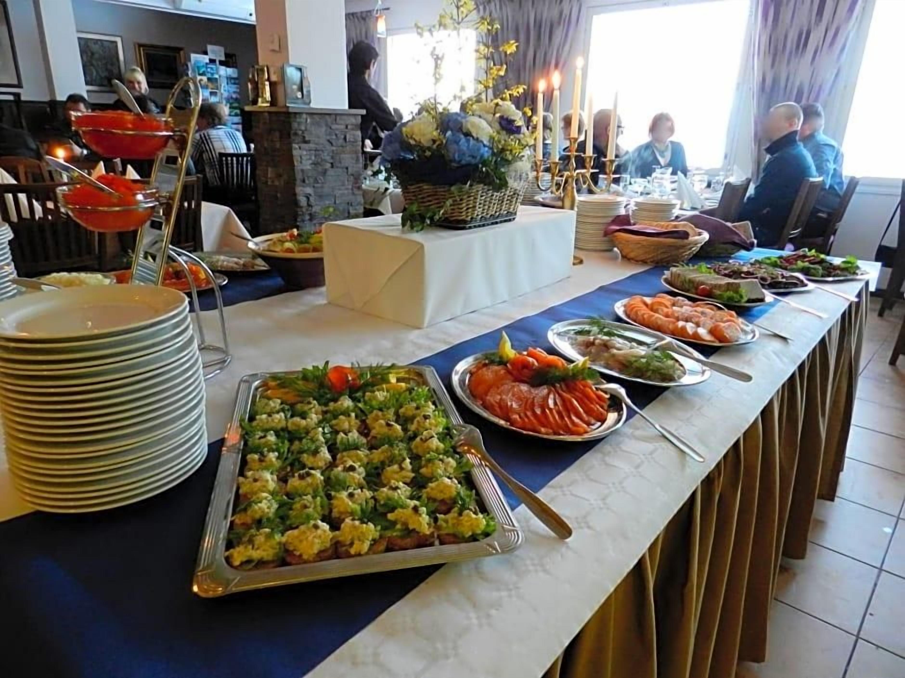 A buffet setup with various dishes and a decorative centerpiece.