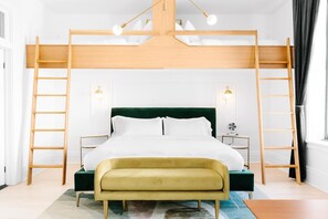 A modern bedroom with a bunk bed, a bedside table, a lamp, and a bench. - The Wyman Hotel & Inn (Silverton)