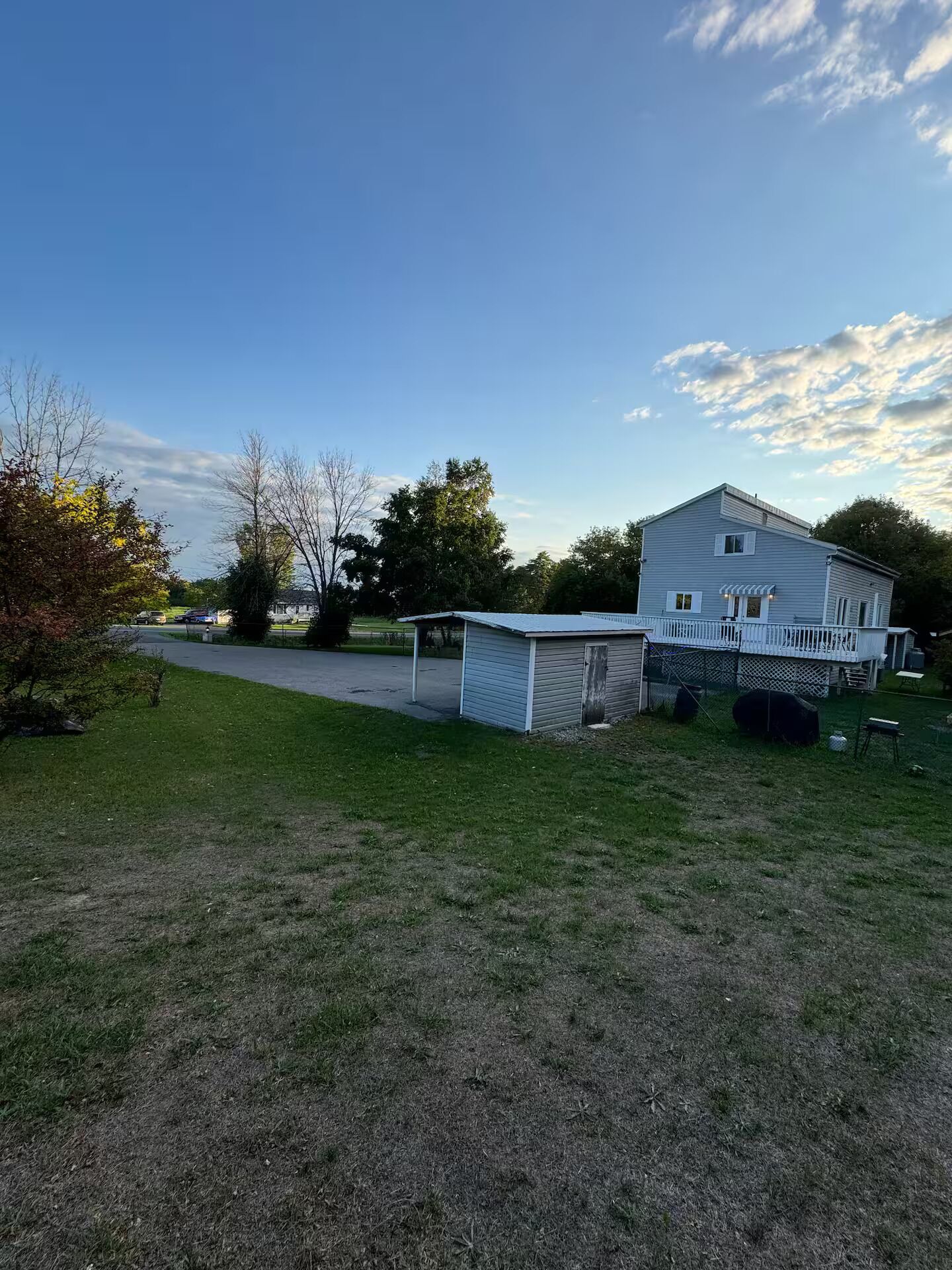 A two-story house with a fenced yard and a covered porch.