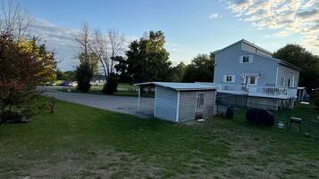 A two-story house with a fenced yard and a covered porch.