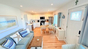 A modern apartment with a living room, dining area, and kitchen. - The Breakaway Beach Condo (North Wildwood)