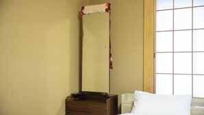 A hotel room with a wooden nightstand, a bed with white bedding, and a large window with a grid pattern. - rinne 2nd living Nasu Forest (Nasu)