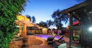 A backyard with a swimming pool, outdoor furniture, and string lights. - NO FEES! Downtown Resort Pool & Gourmet Kitchen (Gilbert)