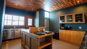 A kitchen with wooden cabinets, a countertop, and a built-in microwave. - YuiLocalZao (Yamagata)