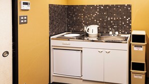 A compact kitchenette with a coffee maker, sink, and a trash bin. - Rinn Manjuji (Kyoto)