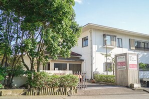 A building with a flat roof, large windows, and a signboard with Japanese text. - Kaze No Mori (Sakai)