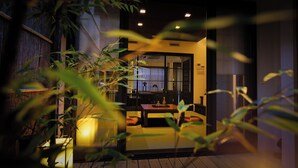 A traditional Japanese room with tatami flooring, a low table, and a sliding door. - Kyo No Yado Gekkoan (Kyoto)