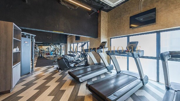 A gym with treadmills, weight machines, and a large window. - Ion Delemon Premier Suites Genting Highlands (Genting Highlands)