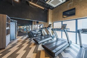 A gym with treadmills, weight machines, and a large window. - Ion Delemon Premier Suites Genting Highlands (Genting Highlands)