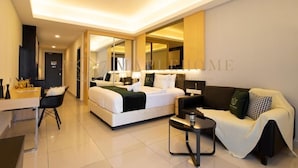 A modern hotel room with a large bed, a sofa, a desk, and a mirror. - Ion Delemon Premier Suites Genting Highlands (Genting Highlands)