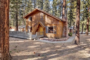 A wooden cabin with a porch, surrounded by tall pine trees. - Paradise In Cedar #2095 (Big Bear Lake)