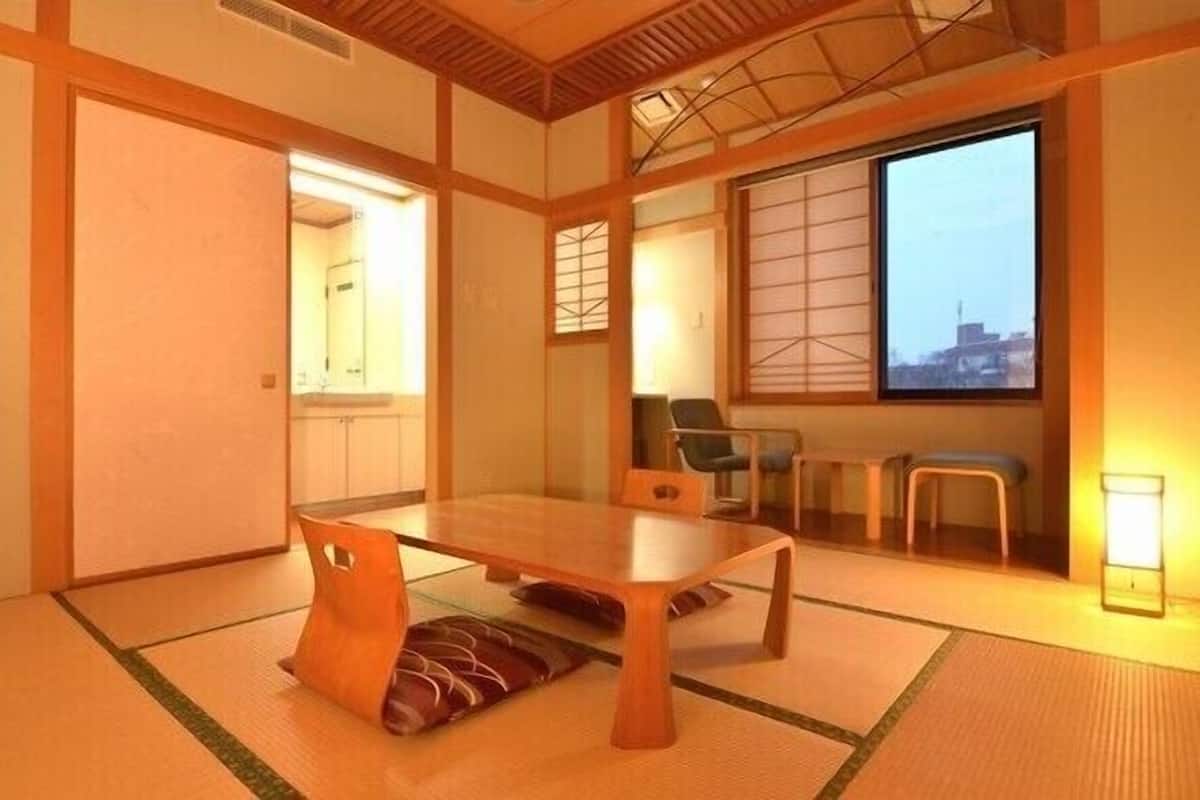 A traditional Japanese room with tatami flooring, a low wooden table, and sliding doors.