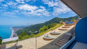 A staircase with a view of a beach and hills. - Litz Resort Batumi (Batumi)