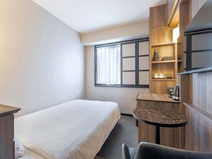A hotel room with a bed, a small table, a chair, a desk, a shelf with items, and a window with curtains. - Sun Hotel Fukuyama (Fukuyama)