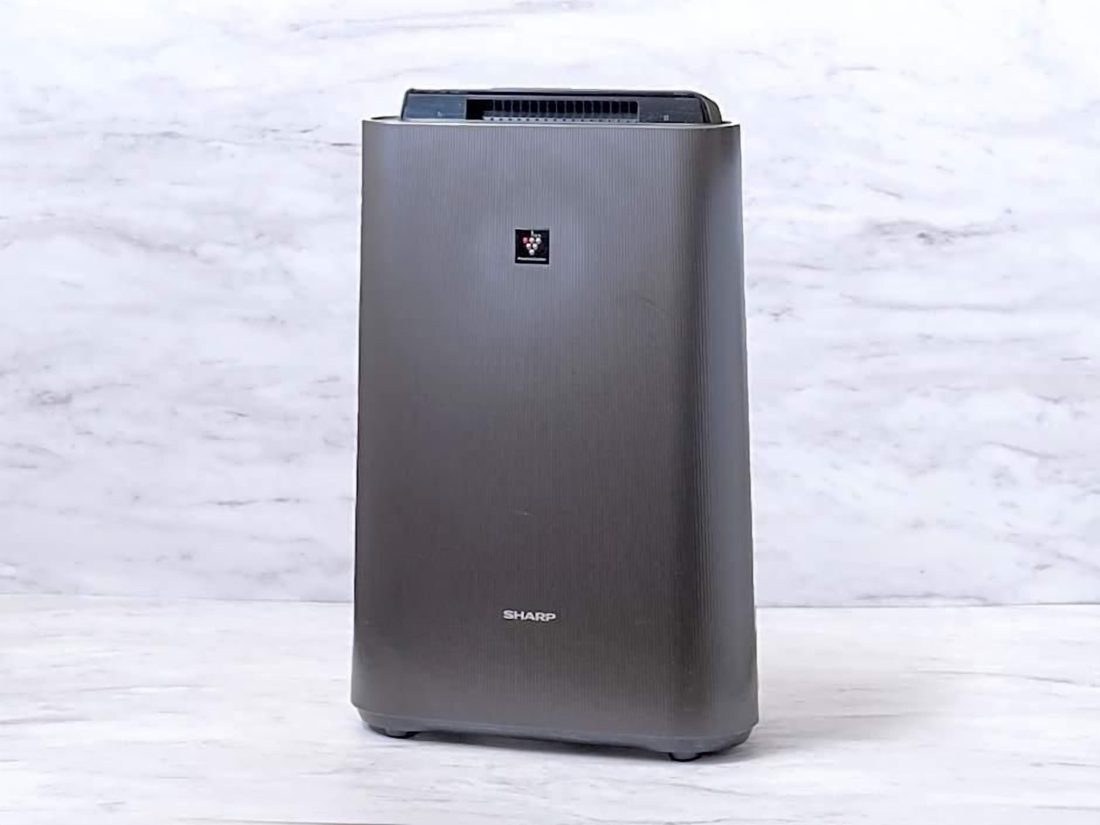 A tall, rectangular air conditioner unit with a metallic finish and a logo on the top.