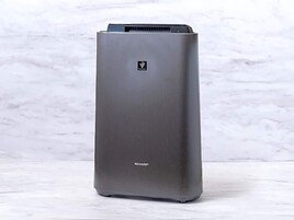 A tall, rectangular air conditioner unit with a metallic finish and a logo on the top.