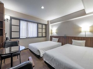 A hotel room with two single beds, a small desk with a chair, a window with curtains, and a wall-mounted lamp. - Sun Hotel Fukuyama (Fukuyama)