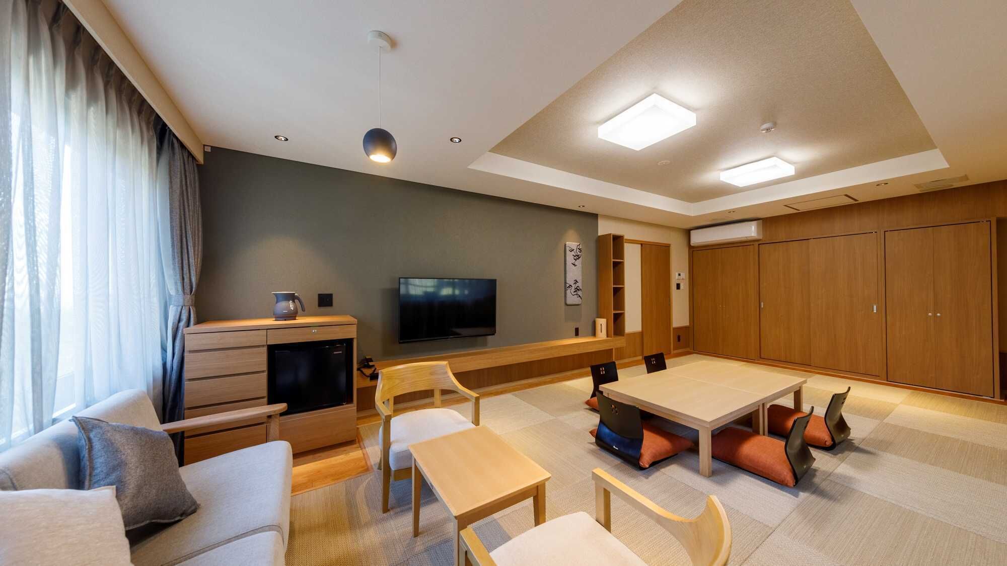 A modern living room with a sofa, coffee table, TV, and a dining area with chairs and a table.