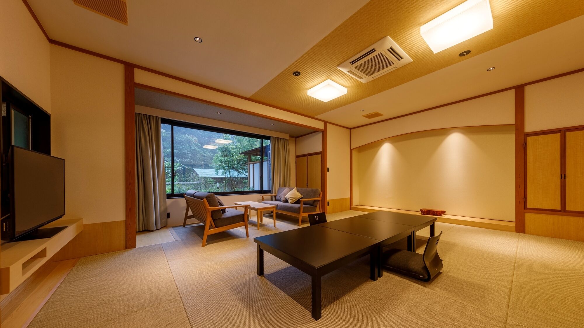 A modern living room with a sofa set, a TV, and a dining table.