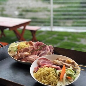 A meal with various dishes including noodles, meat, and vegetables. - Villa Charme (Motobu)