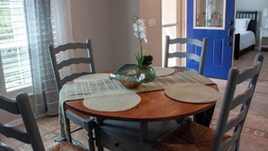 A dining area with a wooden table, woven placemats, and chairs with woven seats. - Relaxing 4-bedroom Pool Oasis Near Daytona (Port Orange)
