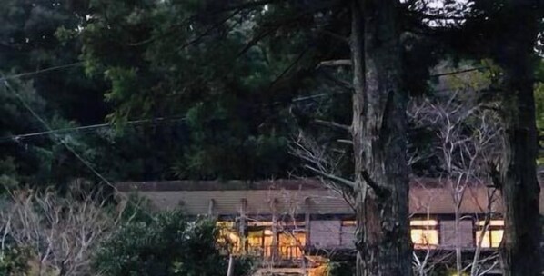 A building with a brick exterior, surrounded by trees. - Kohanso (Isumi)