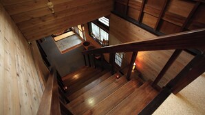 A wooden staircase leading to a room with a window and a door. - Kohanso (Isumi)