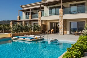 A modern two-story building with a swimming pool, outdoor seating, and a view of the landscape. - Electra Kefalonia Hotel and Spa (Kefalonia)