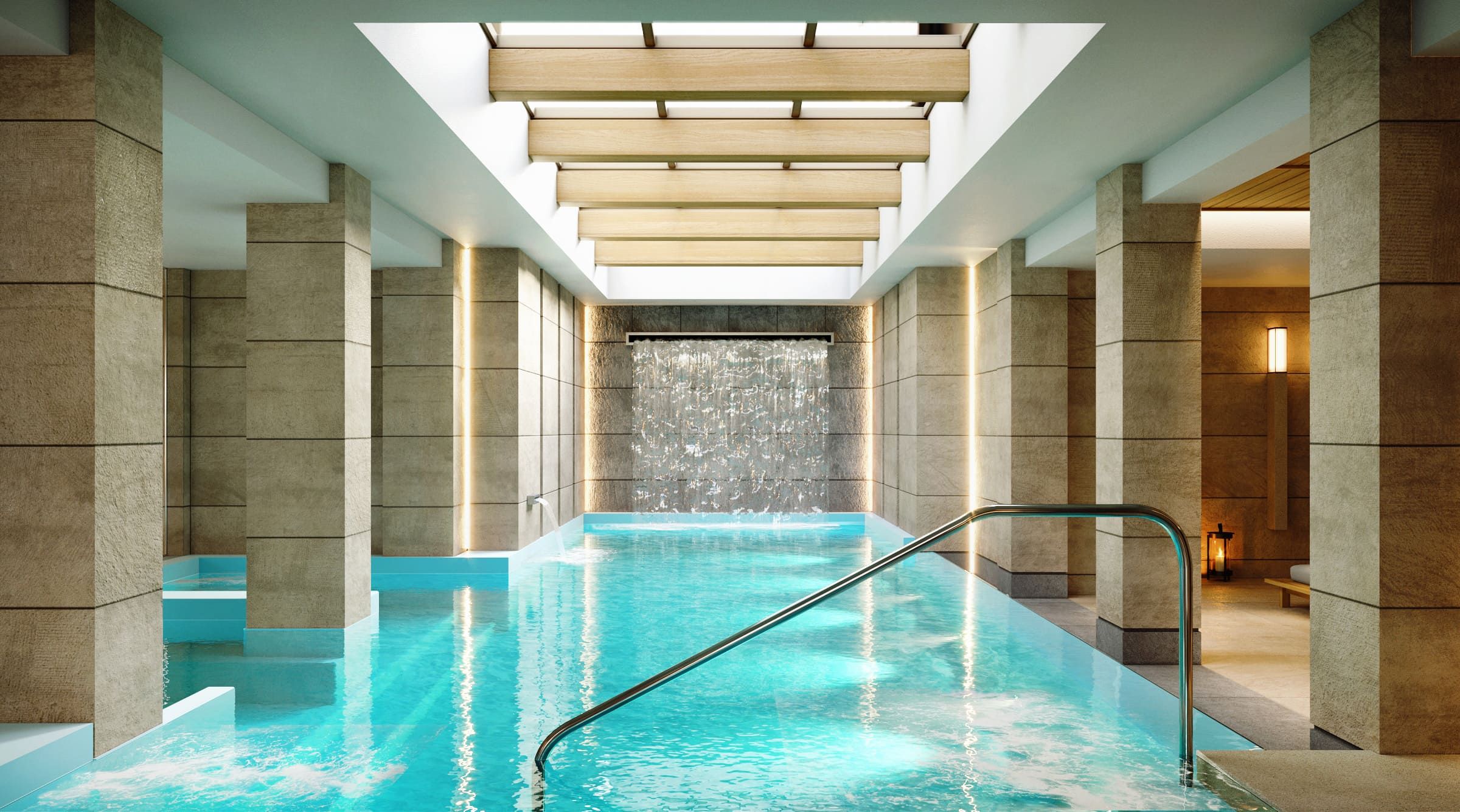 Una piscina interior moderna con agua cristalina, una escalera metálica y una cascada.
