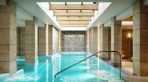 A modern indoor pool with clear water, a metal ladder, and a waterfall feature. - Electra Kefalonia Hotel and Spa (Kefalonia)