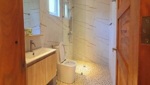 A modern bathroom with a shower, toilet, and sink. - Pili Beach Resort Agmanic By Zuzu (Santa Fe)