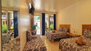 A hotel room with two beds, a TV mounted on the wall, and a balcony with a view of greenery. - Pili Beach Resort Agmanic By Zuzu (Santa Fe)