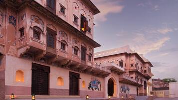A traditional building with multiple balconies and arched windows.