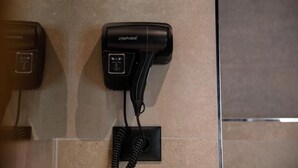 A hairdryer and a telephone mounted on a wall. - Furra Hotel (Gjirokastër)