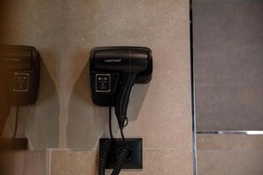 A hairdryer and a telephone mounted on a wall. - Furra Hotel (Gjirokastër)