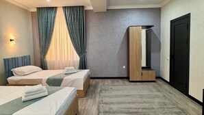 A modern hotel room with two beds, a large mirror, a wardrobe, and a carpeted floor. - Mehran (Fergana)