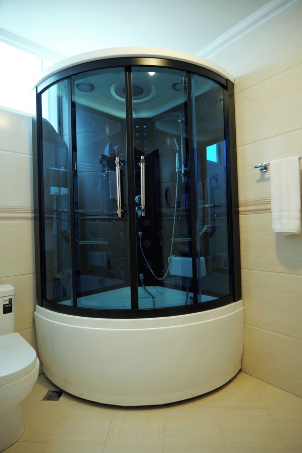 A modern bathroom with a glass-enclosed shower, a toilet, and a towel rack. - Crescent International Hotel Bole (Addis Ababa)