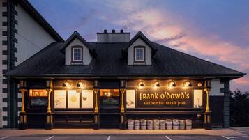 A pub with a dark roof, two dormer windows, and a sign reading "Frank O'Dowd's authentic Irish pub".