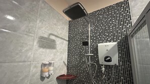 A bathroom with a shower, a soap dispenser, and a hand dryer. - Abc Hostel By Zuzu (Seri Kembangan)